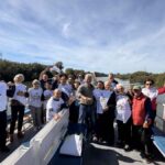 Partecipanti alla navigazione sul Tevere da Ponte Marconi a Ostia Antica, a Roma, mostrano le magliette della campagna ANVCG “Stop alle bombe sui civili”.